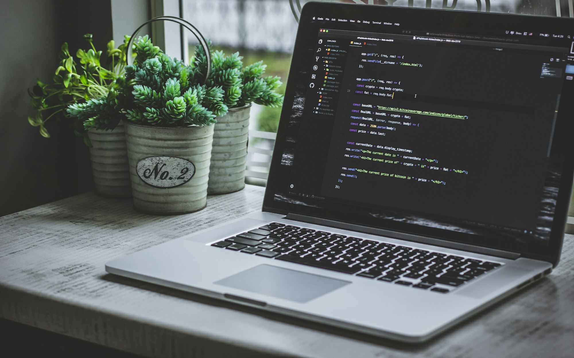Placeholder photo: a MacBook at an angle with an editor of code on screen